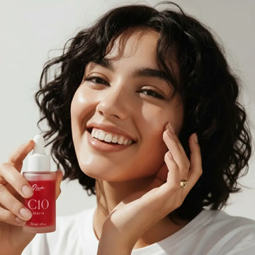 Discover our C10 serum with this image featuring a radiant woman smiling while holding the product. Perfect for showcasing glowing skin results, anti-aging benefits, and vitamin C skincare. This beauty shot highlights the effectiveness of C10 serum for a healthy complexion.